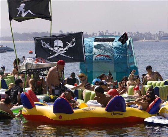 Revelers show up for the floating party off Fanuel Street Park in Pacific Beach dubbed \"Floatopia.\" on March 20, 2010 in San Diego. San Diego's City Council may let the air out of so-called \"floatopia\" parties where people booze it up on inner tubes offshore. The council meets Monday afternoon to consider closing a loophole in the city's ban on the beach use of alcohol. (AP Photo/San Diego Union-Tribune, Nelvin C. Cepeda) ** SAN DIEGO COUNTY OUT, NO SALES, COMMERCIAL INTERNET OUT, FOREIGN OUT, MANDATORY CREDIT, TV OUT **